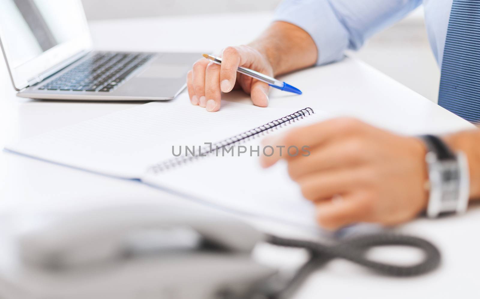 business, office, school and education concept - businessman writing in notebook