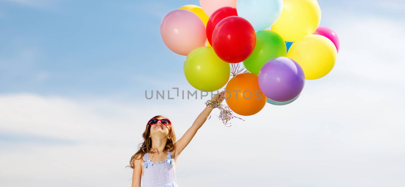 happy girl with colorful balloons by dolgachov