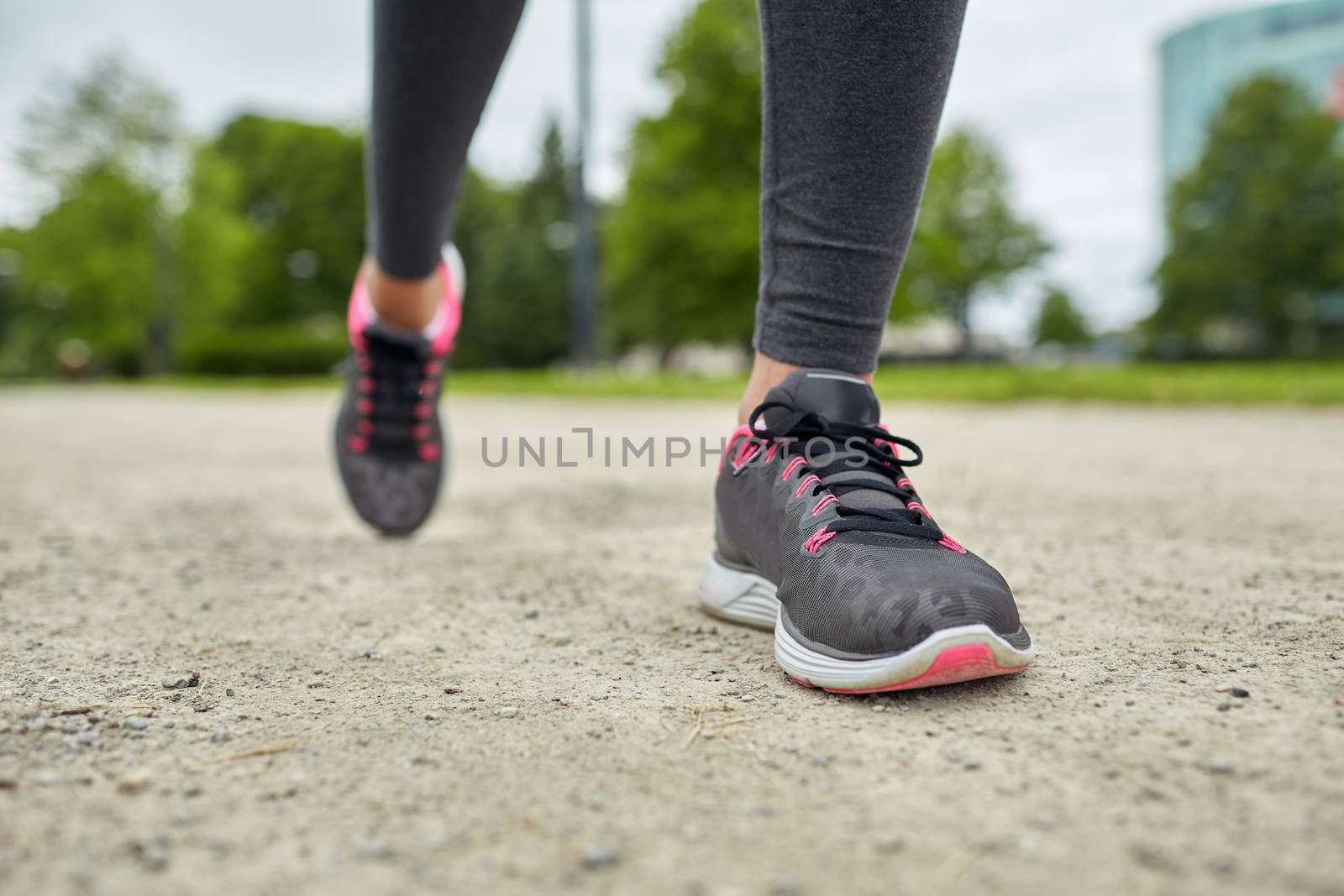 fitness, sport, training, people and lifestyle concept - close up of woman feet running on track from back