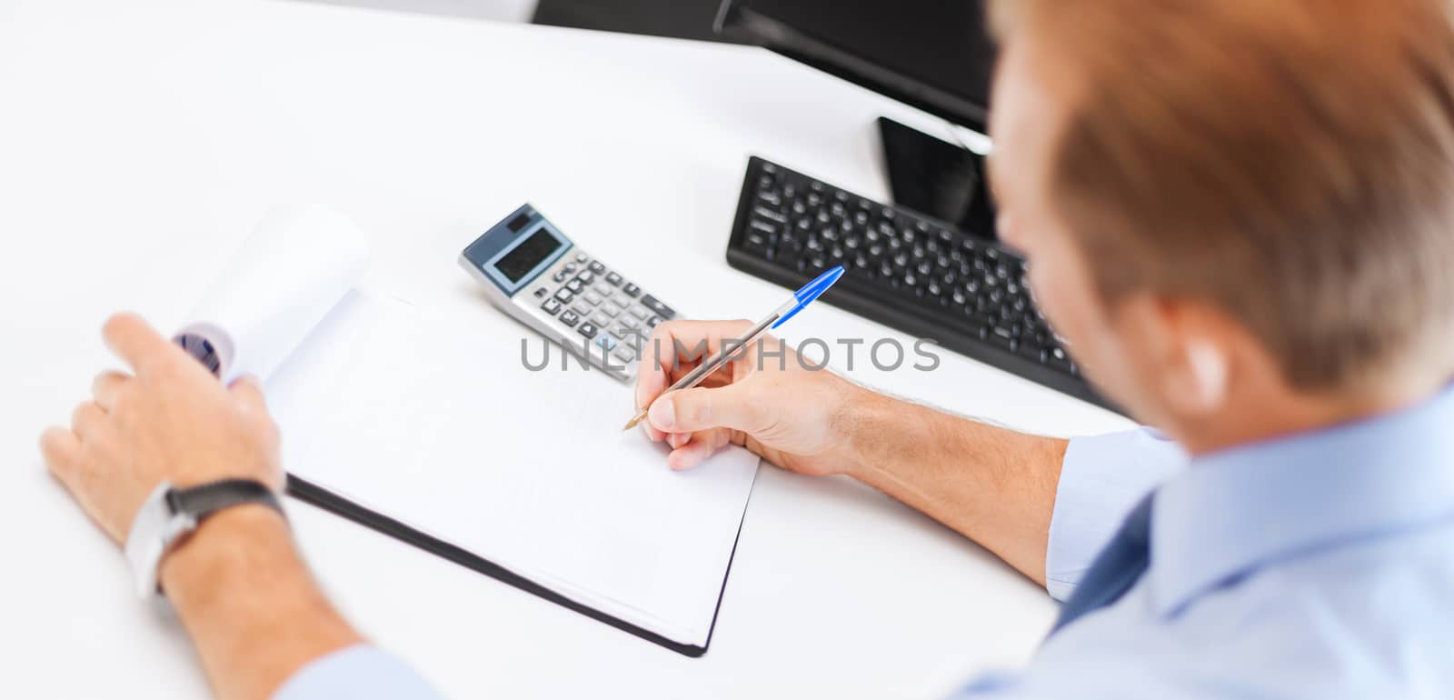 businessman with notebook and calculator by dolgachov
