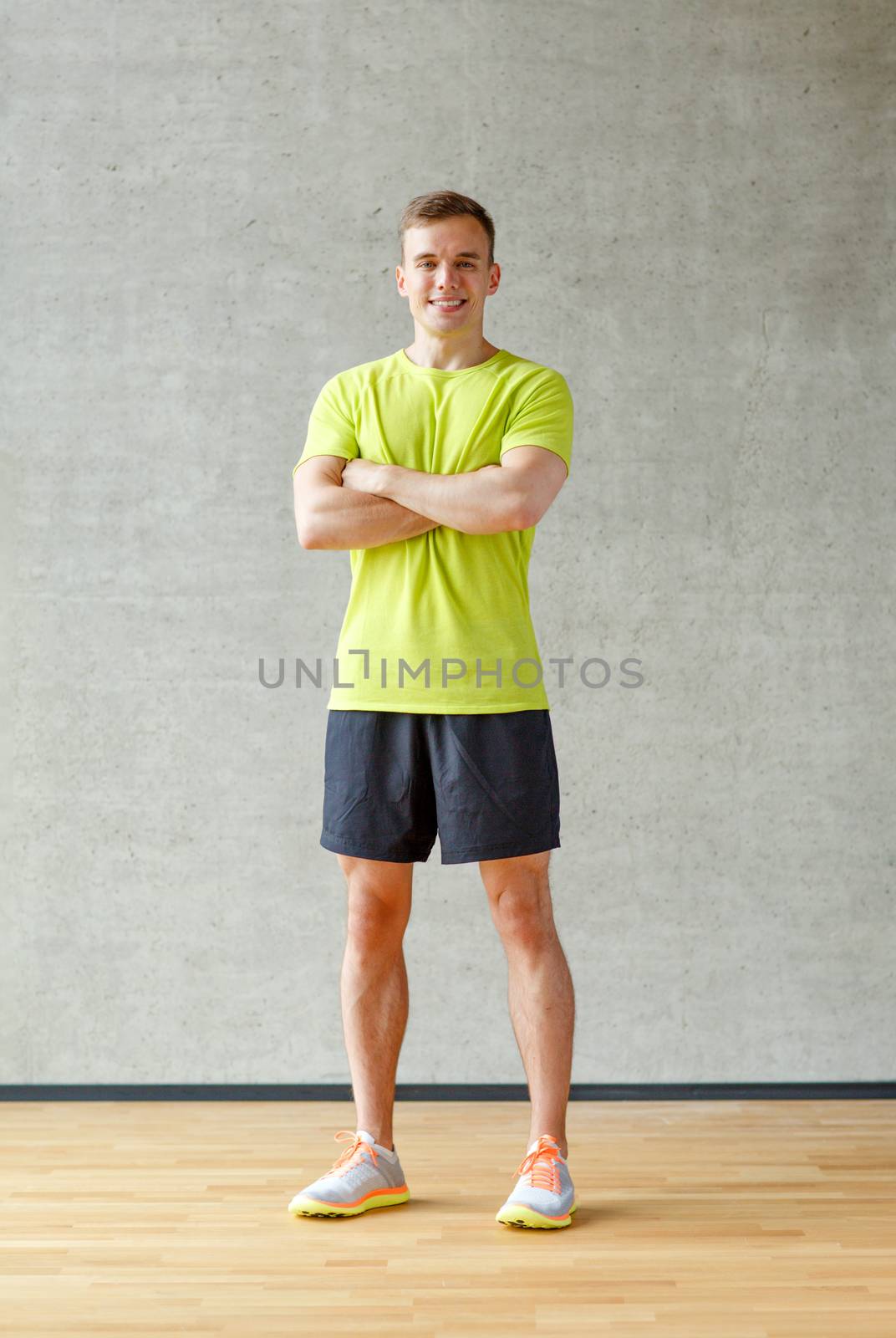 smiling man in gym by dolgachov