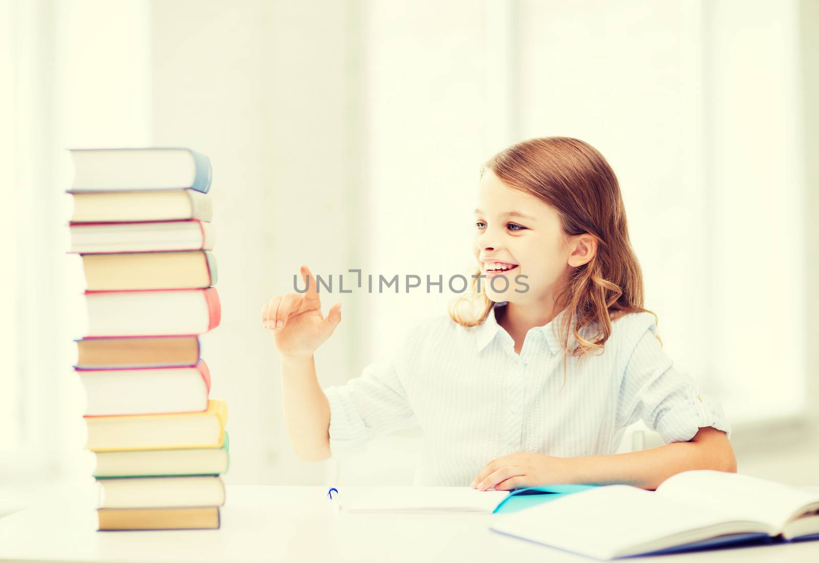 education and school concept - little student girl studying at school