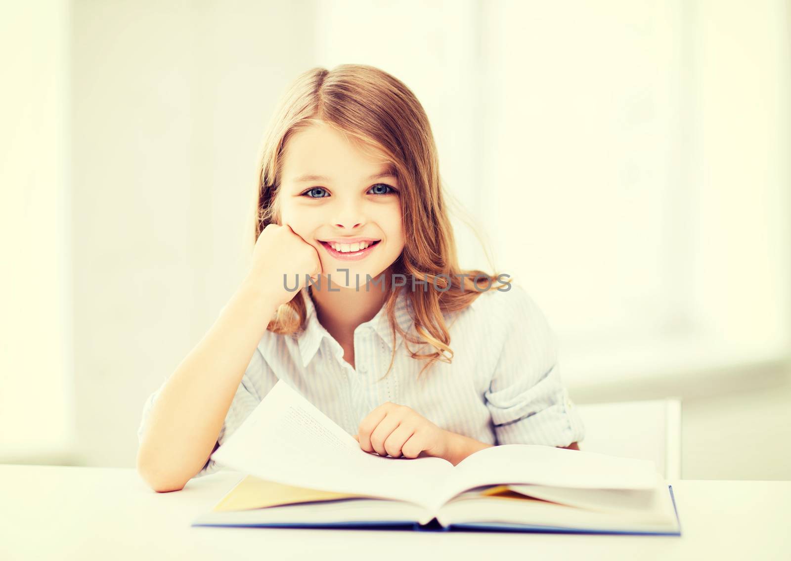 education and school concept - little student girl studying at school