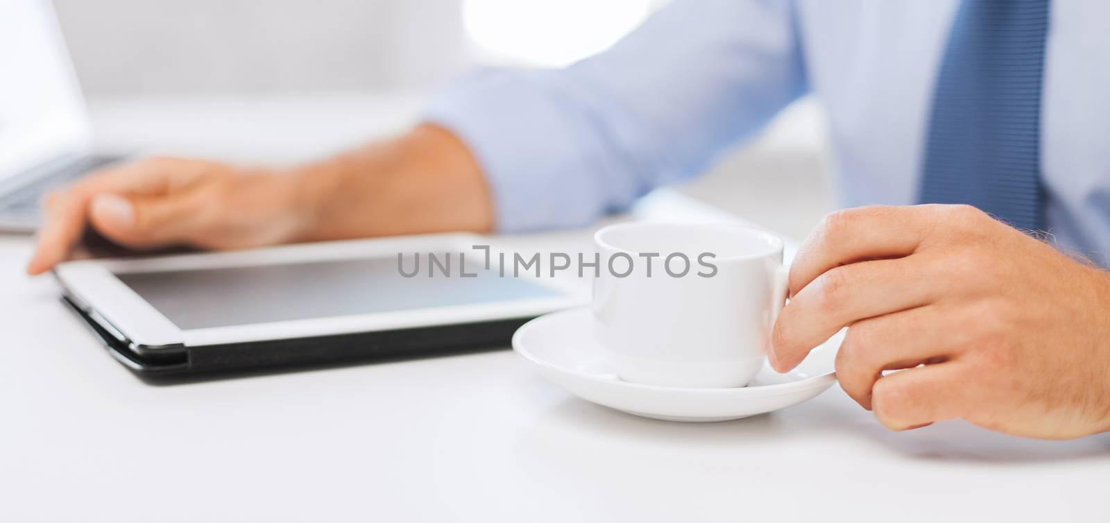 business, office, school and education concept - businessman with tablet pc drinking coffee in office