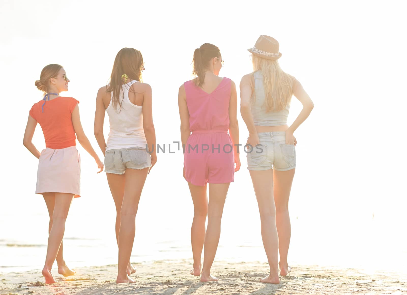 summer vacation, holidays, travel, friendship and people concept - group of young women walking on beach