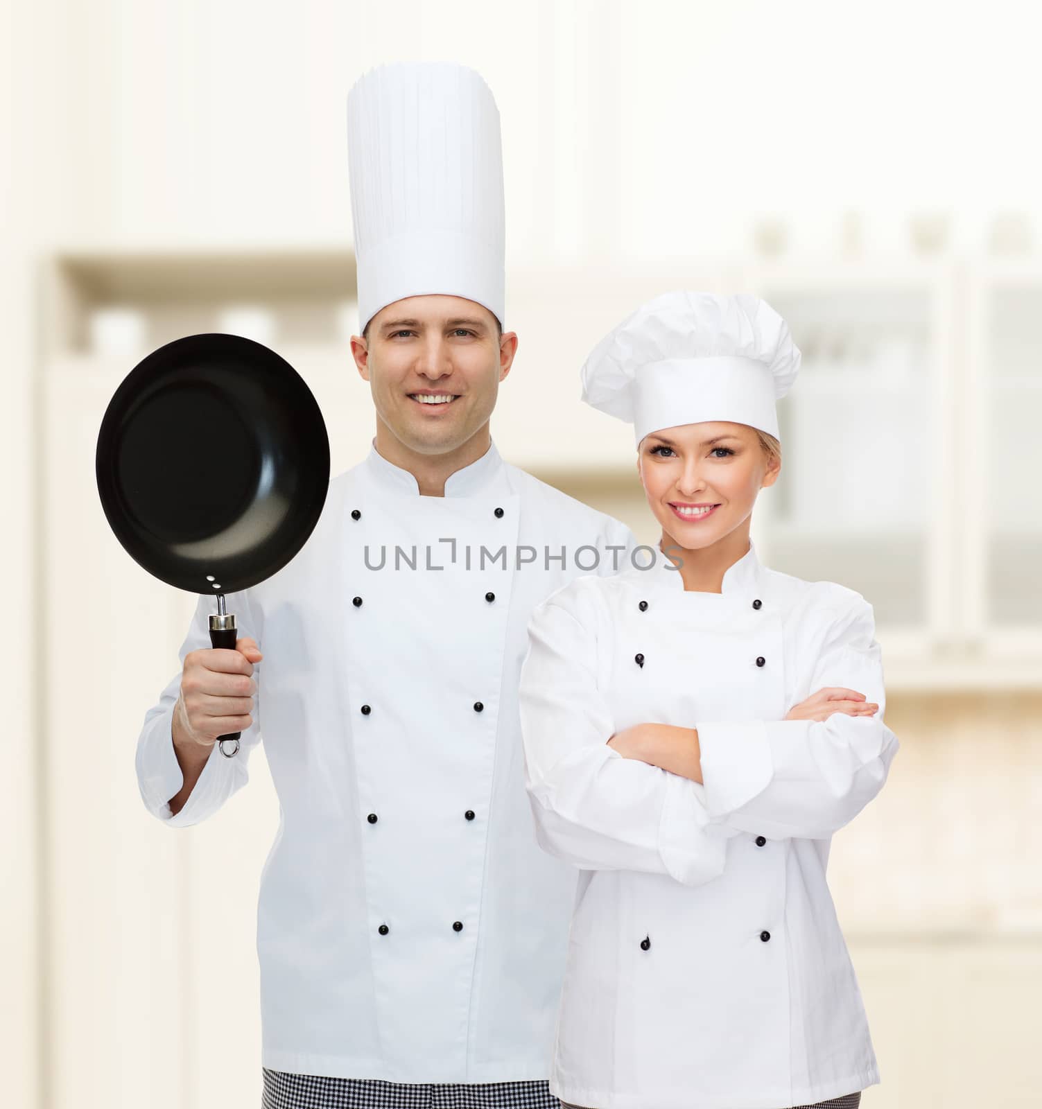 cooking, profession and people concept - happy male chef cook holding frying pan
