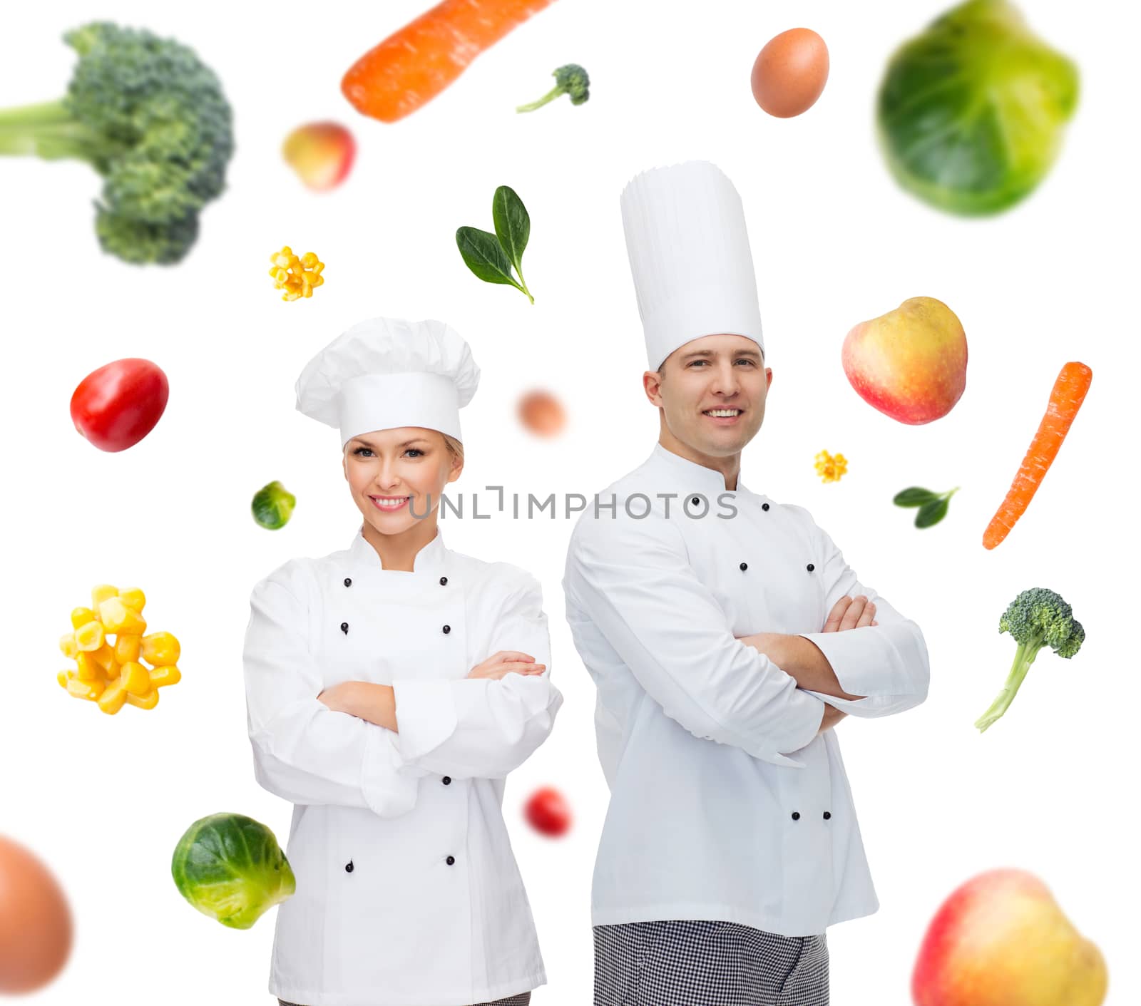 happy chef couple or cooks over food background by dolgachov