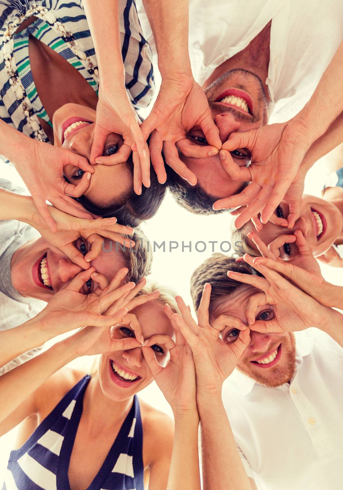 friendship, happiness and people concept - smiling friends in circle