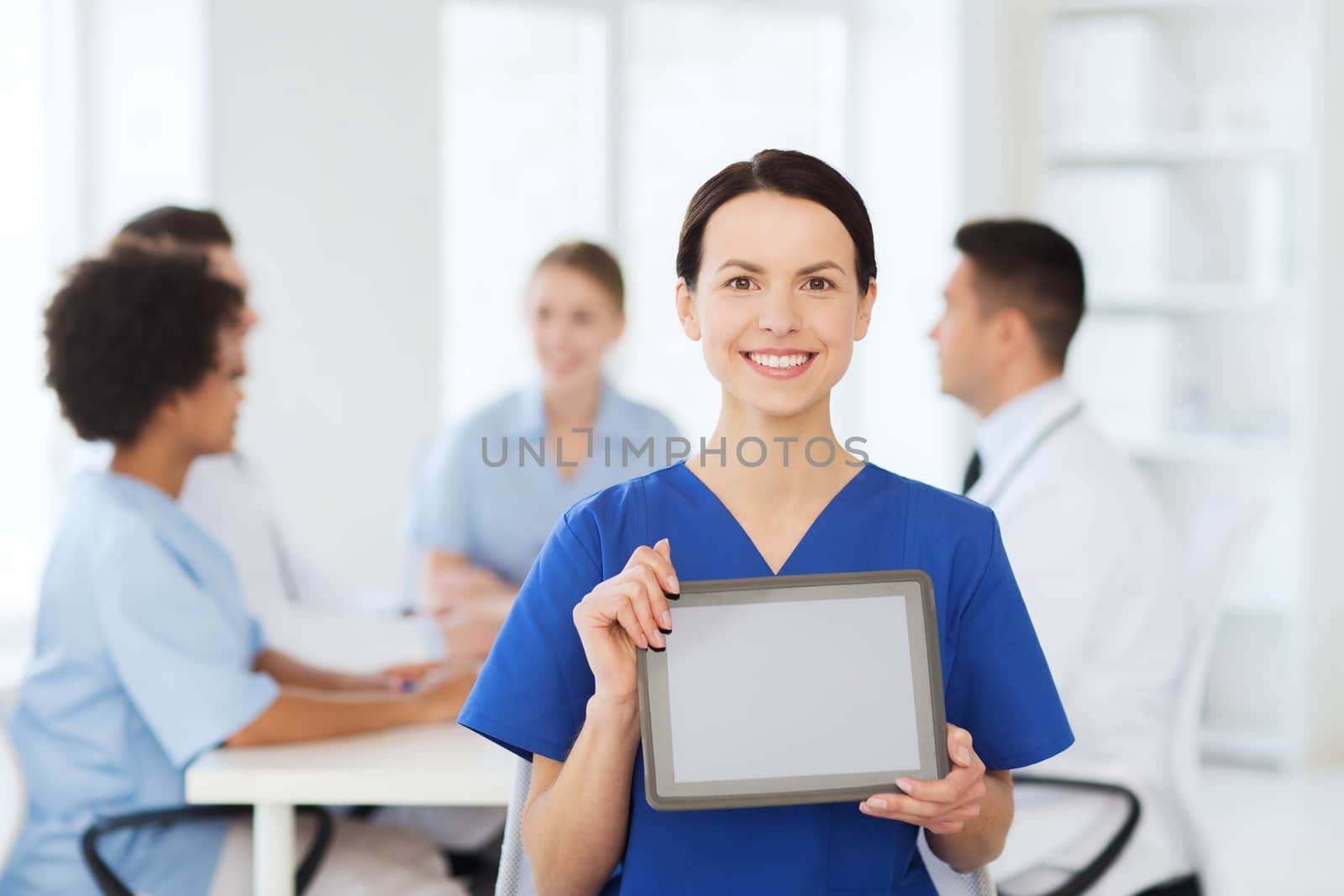 happy doctor over group of medics at hospital by dolgachov