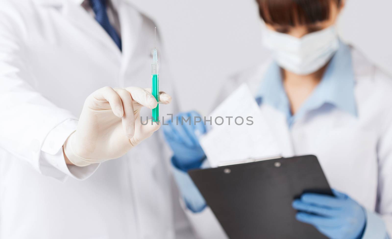 doctors with syringe by dolgachov