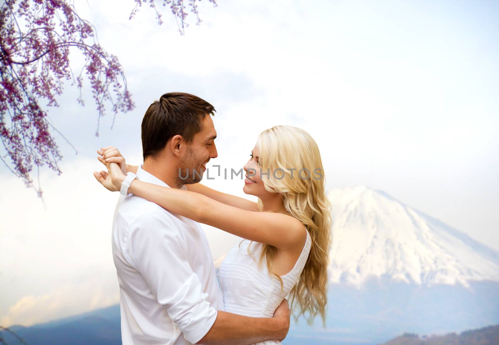 happy couple hugging over fuji mountain in japan by dolgachov