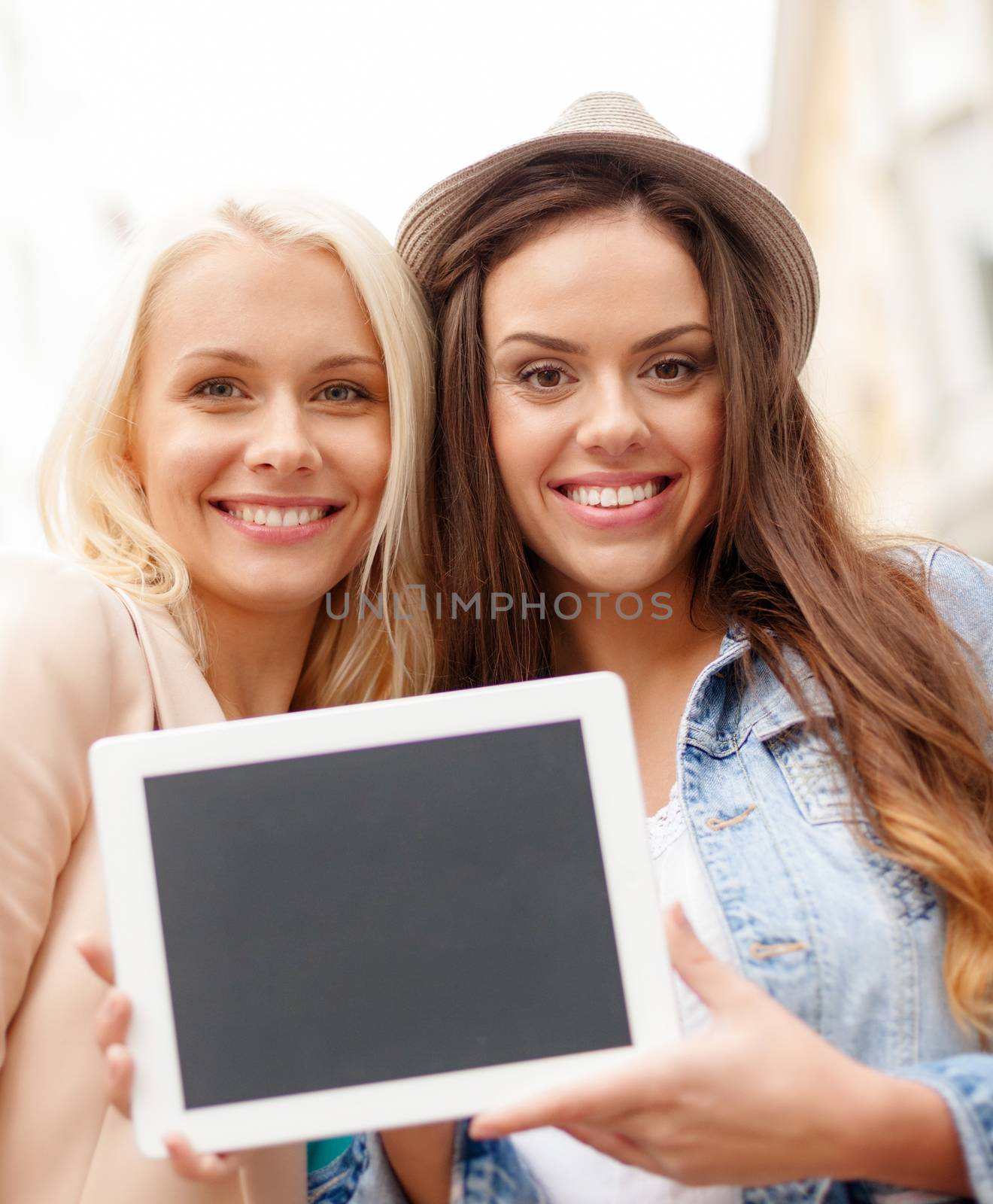 beautiful girls with blank tablet pc screen by dolgachov