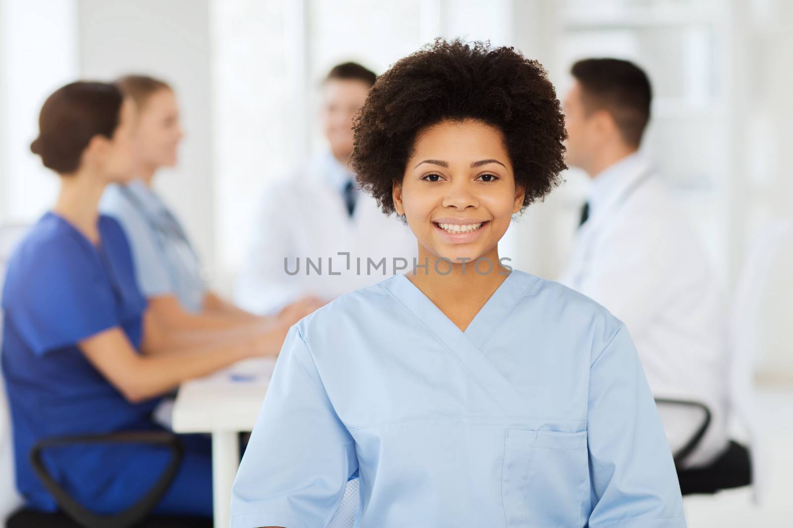 happy doctor over group of medics at hospital by dolgachov