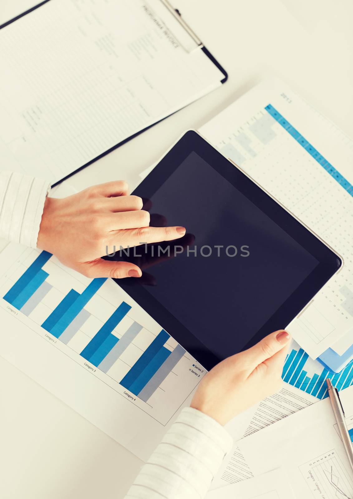 woman with tablet pc and chart papers by dolgachov