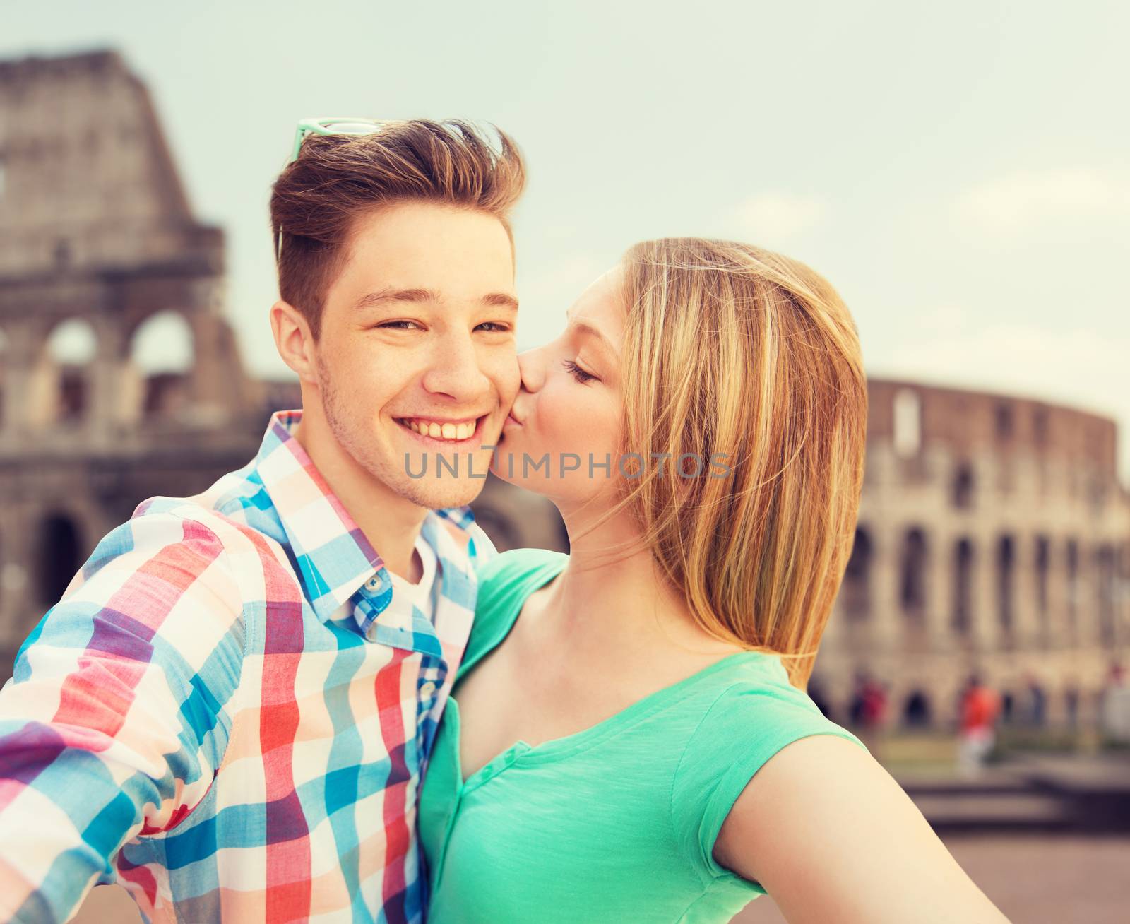 couple kissing and taking selfie over coliseum by dolgachov