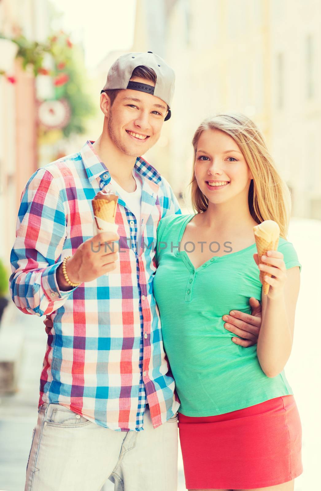 summer, vacation, love and friendship concept - smiling couple with ice-cream in city