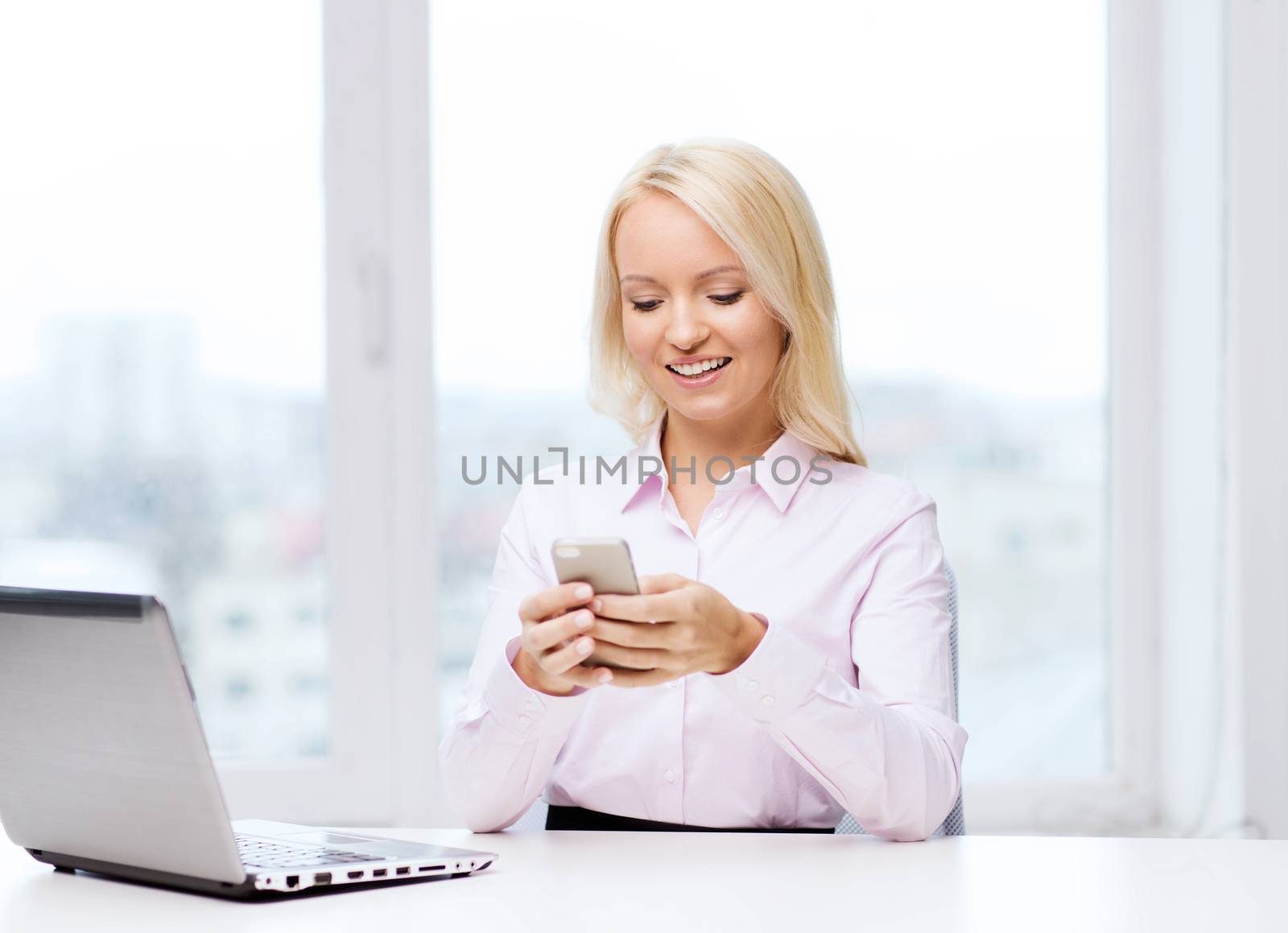 education, business, communication and technology concept - smiling businesswoman or student with smartphone texting message in office