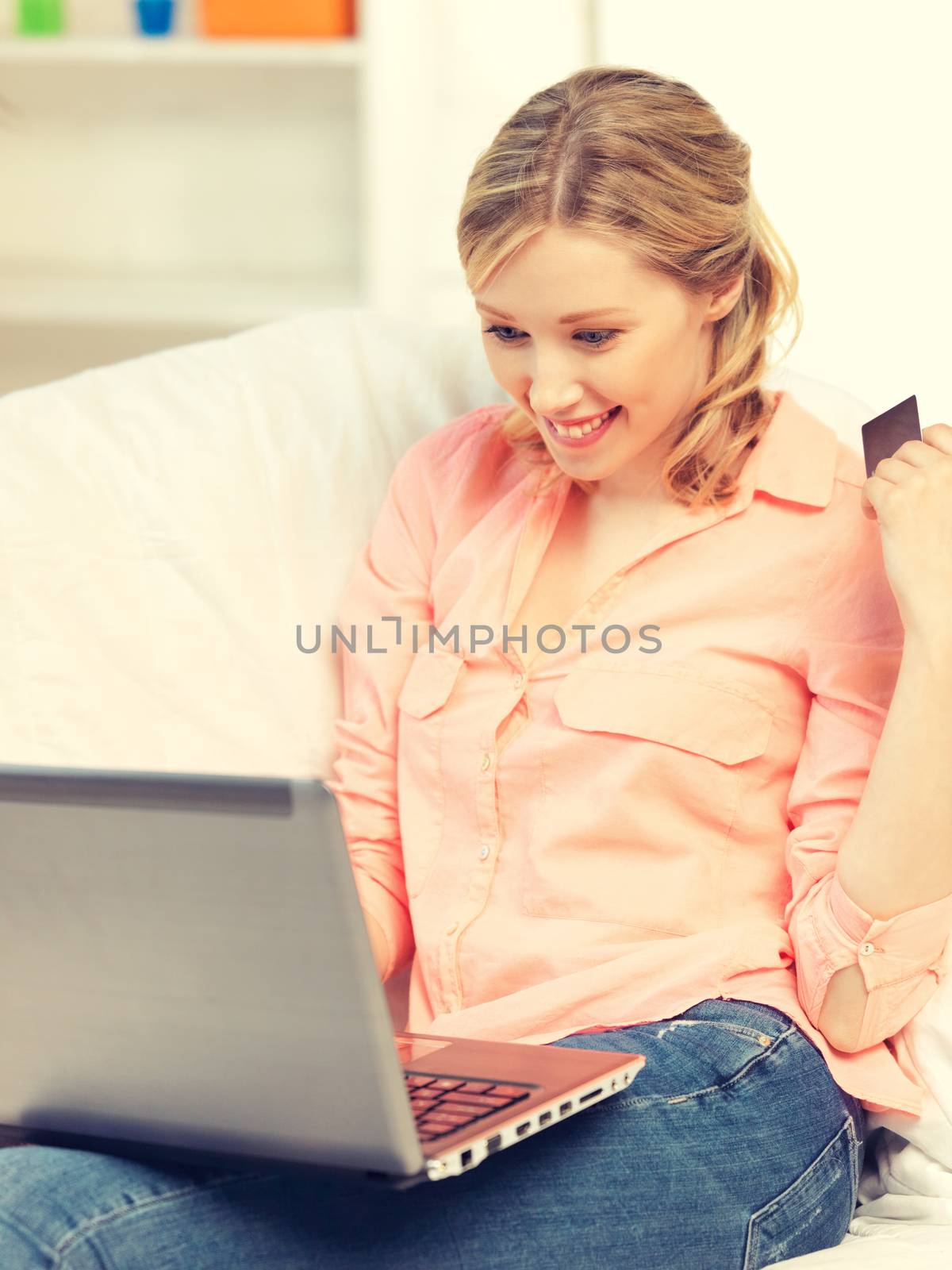 picture of happy woman with laptop computer and credit card..