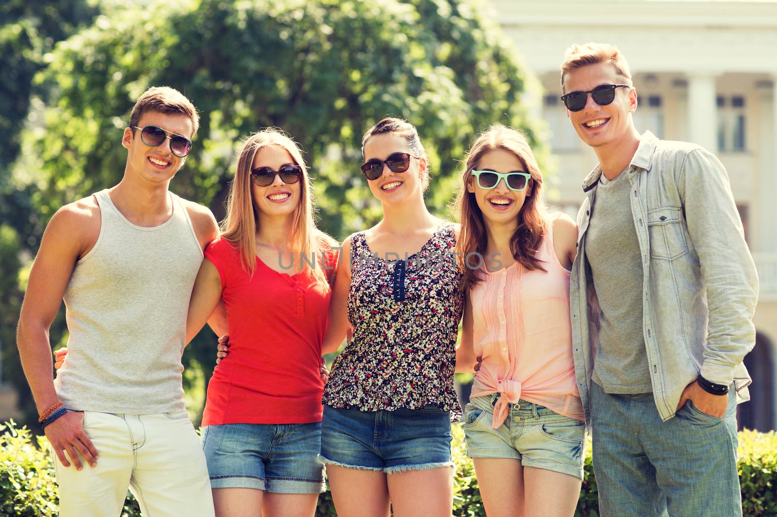 group of smiling friends outdoors by dolgachov