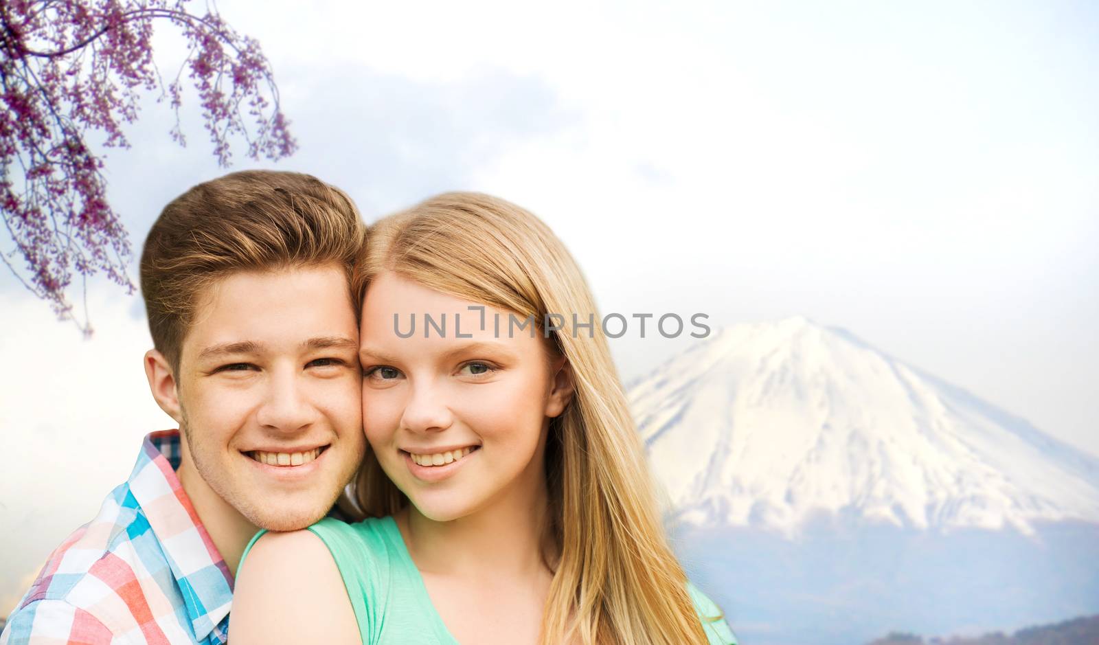 smiling couple hugging over fuji mountain in japan by dolgachov