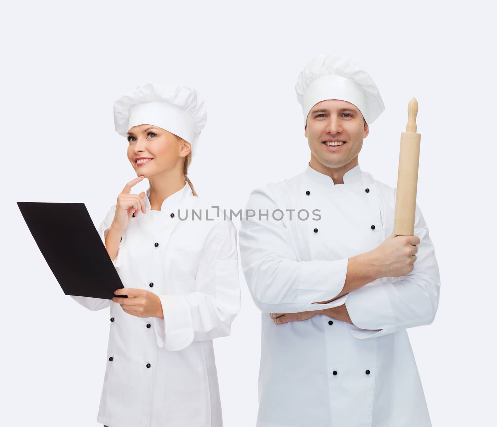 happy male chef cook holding rolling pin by dolgachov