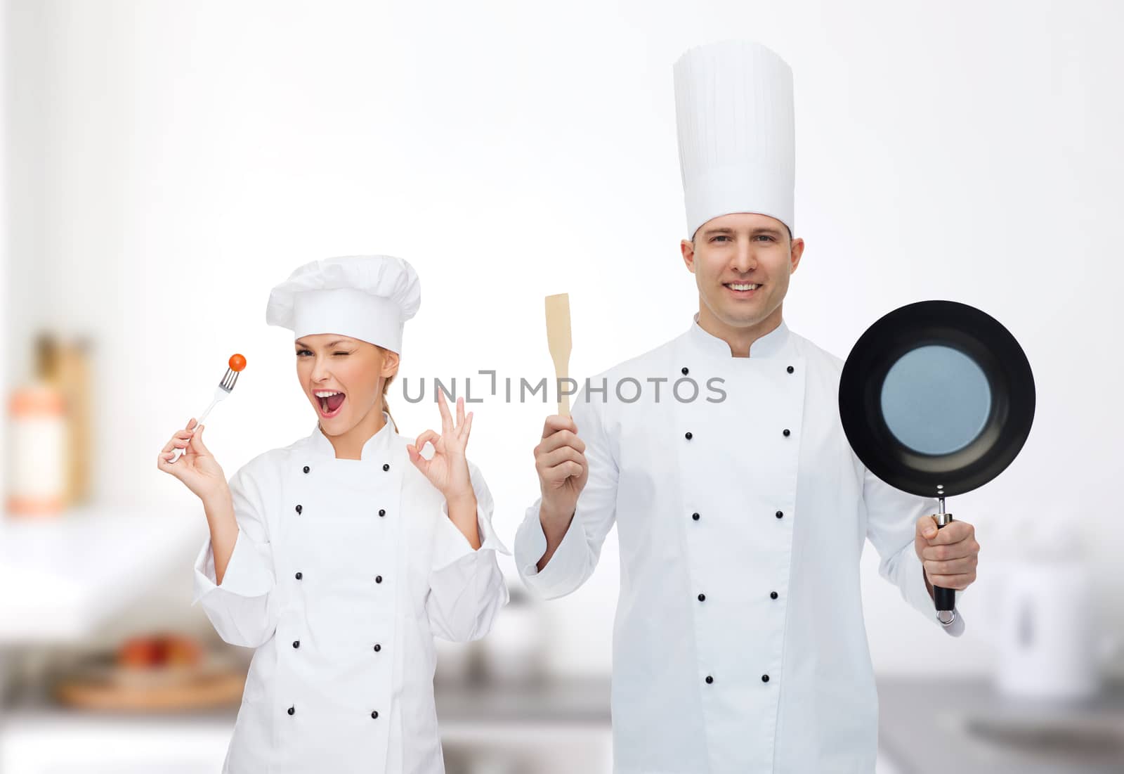 happy male chef holding frying pan and spatula by dolgachov