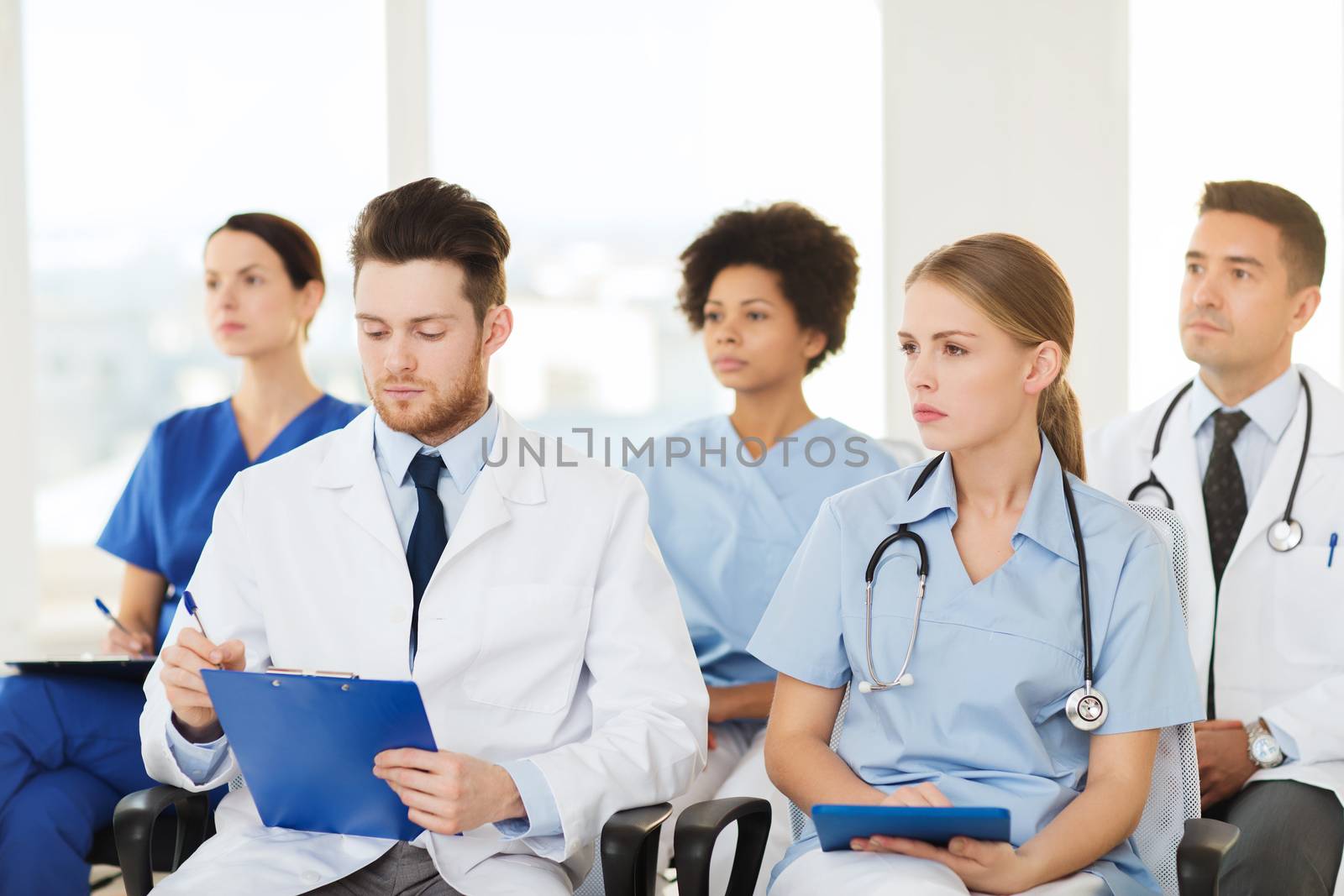 group of happy doctors on seminar at hospital by dolgachov