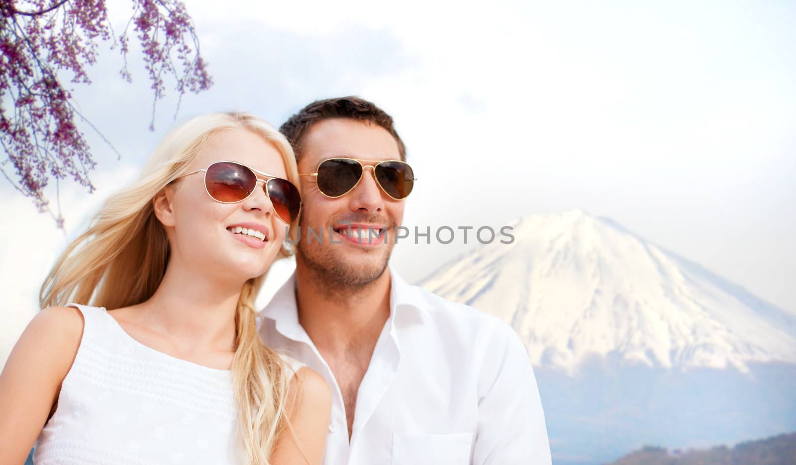 summer holidays and dating concept - couple in shades over fuji mountain background