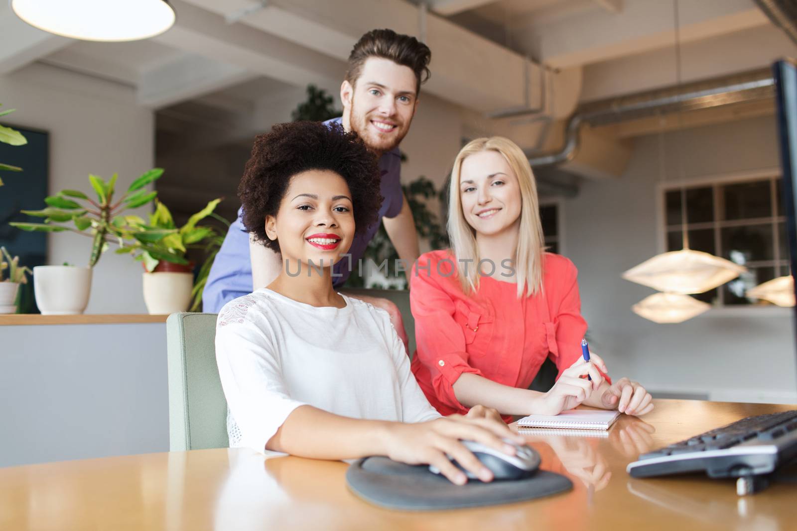 happy creative team in office by dolgachov