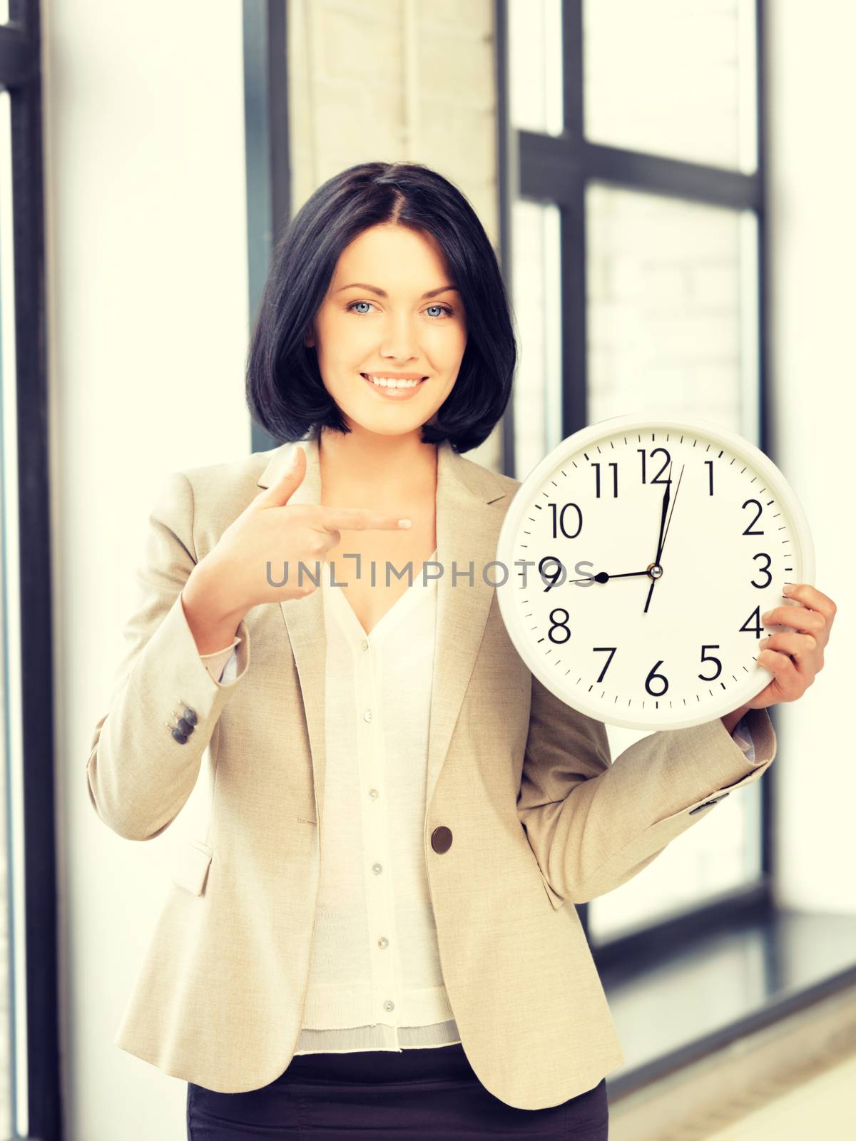 bright picture of attractive businesswoman with clock