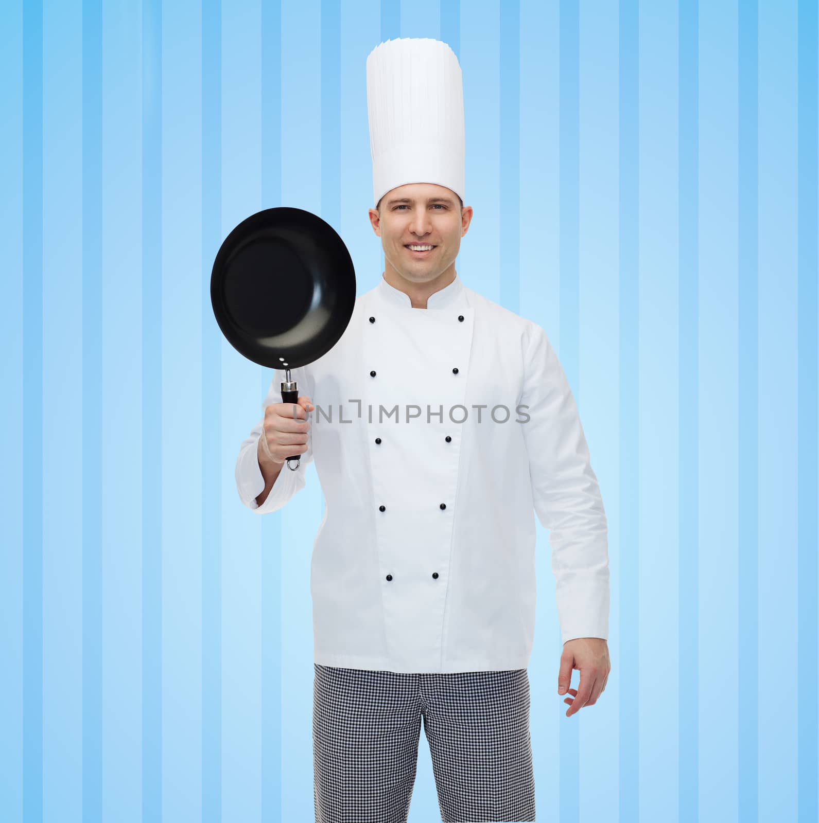 cooking, profession and people concept - happy male chef cook holding frying pan over blue striped background