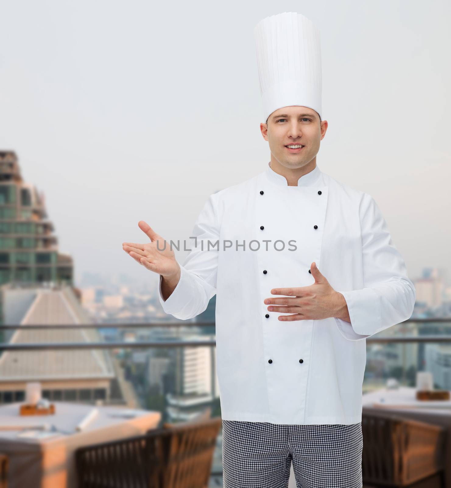 cooking, profession and people concept - happy male chef cook inviting over city restaurant lounge background
