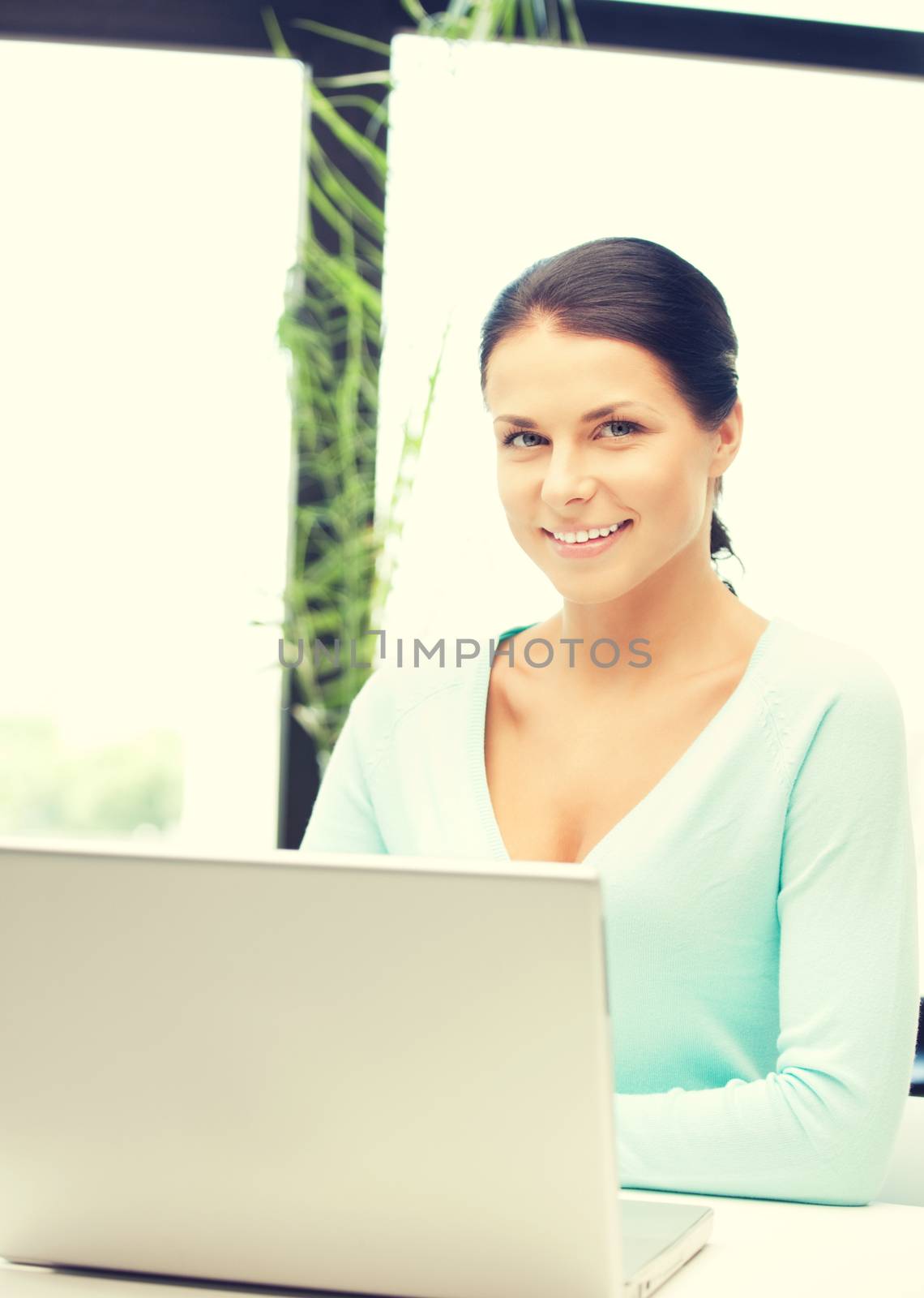 happy woman with laptop computer by dolgachov