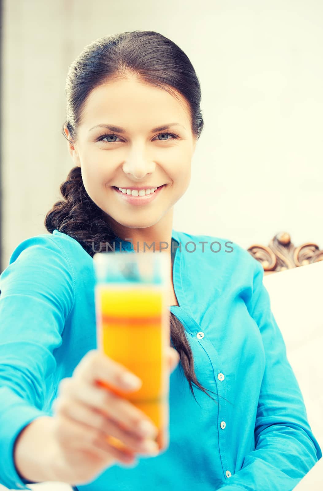 woman holding glass of orange juice by dolgachov