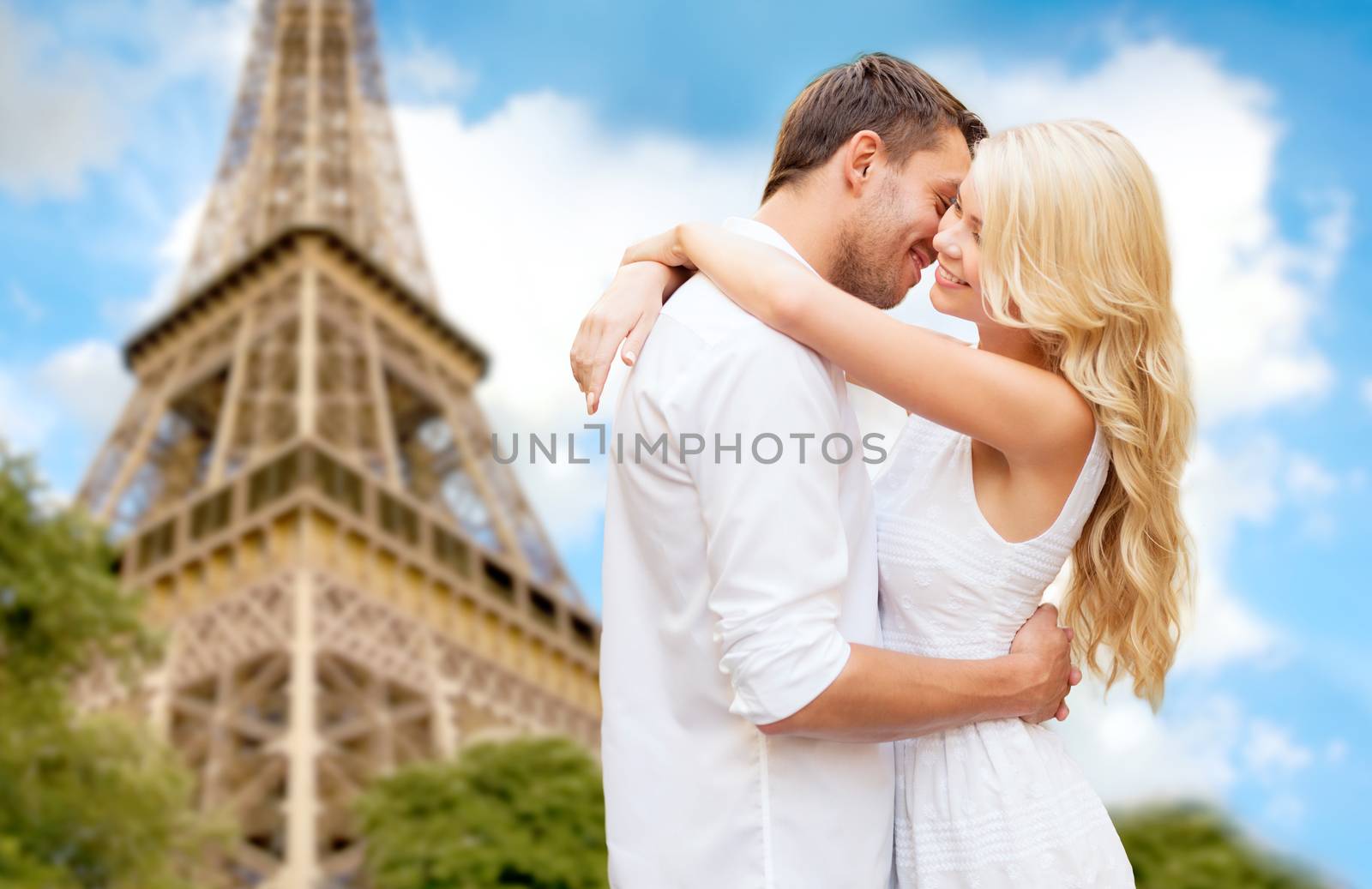 happy couple hugging over eiffel tower by dolgachov