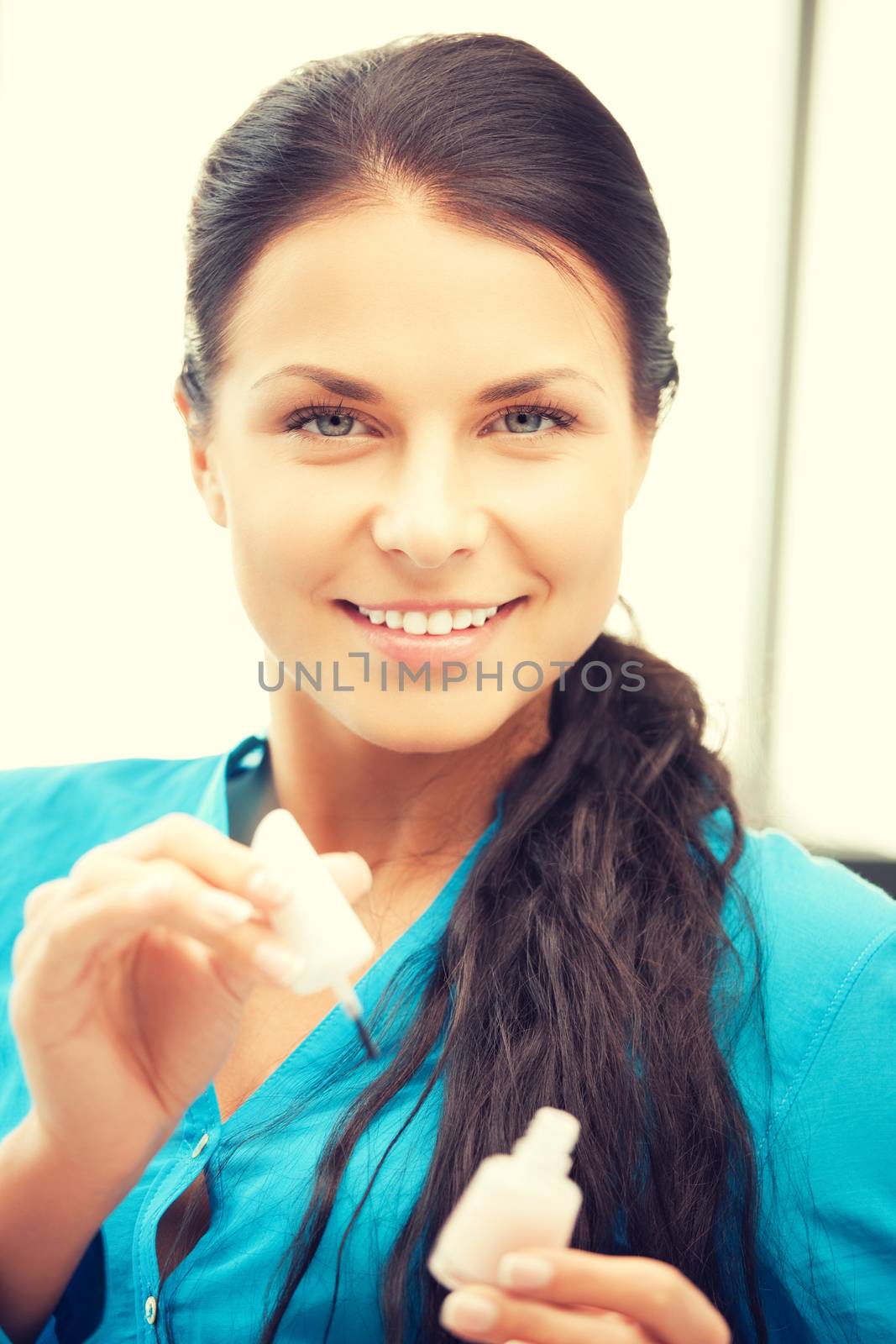 picture of beautiful woman polishing her nails