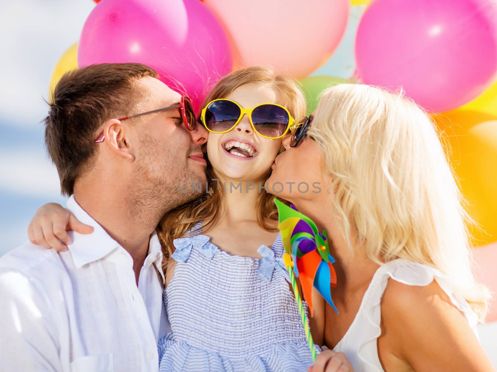 summer holidays, celebration, children and people concept - family with colorful balloons