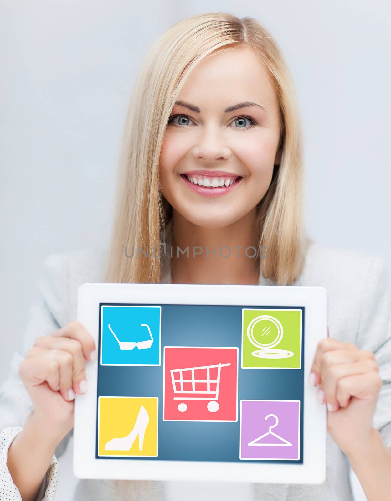 smiling woman showing tablet pc computer screen by dolgachov