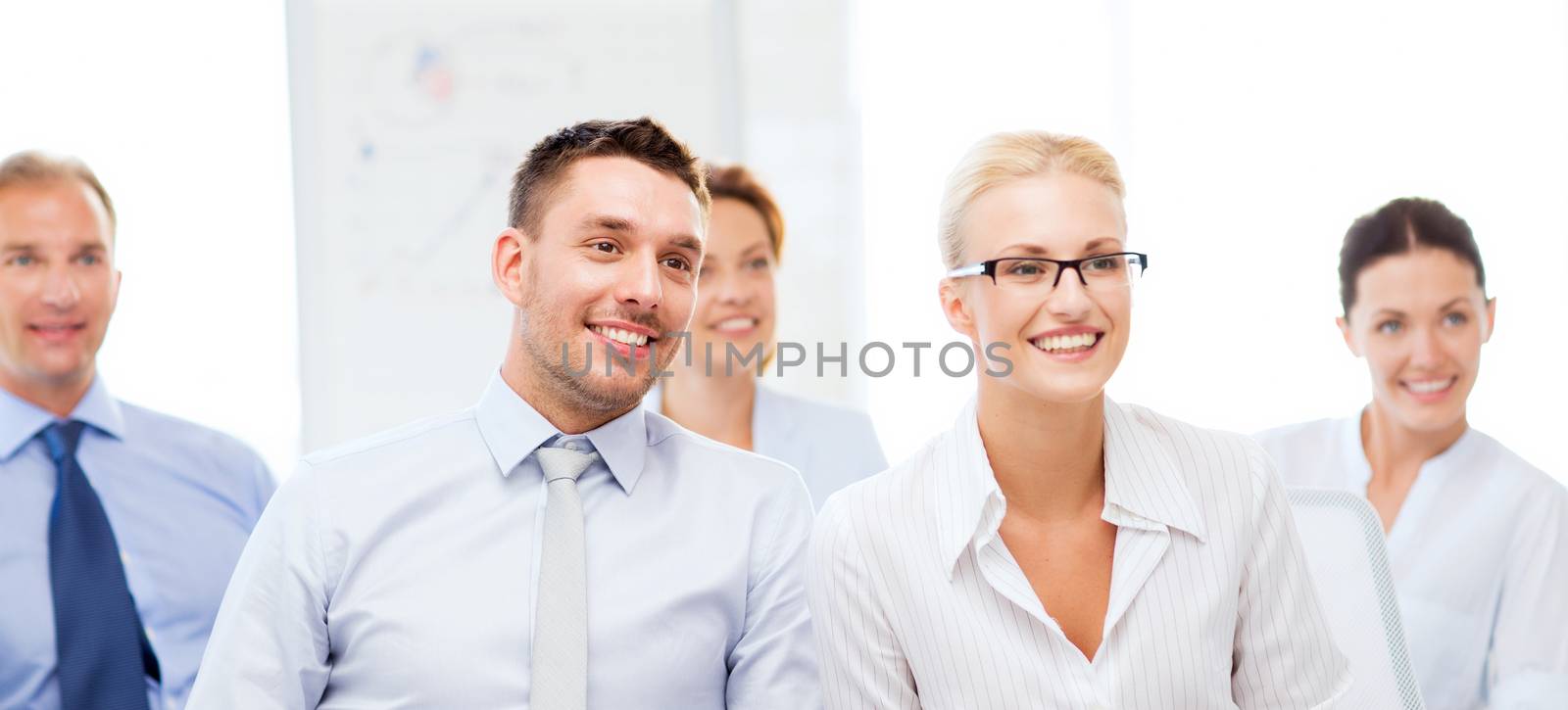 picture of smiling businessmen and businesswomen on conference