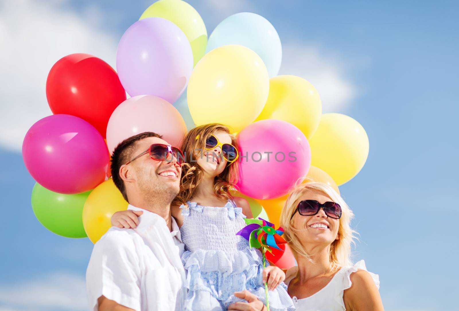 summer holidays, celebration, children and people concept - family with colorful balloons