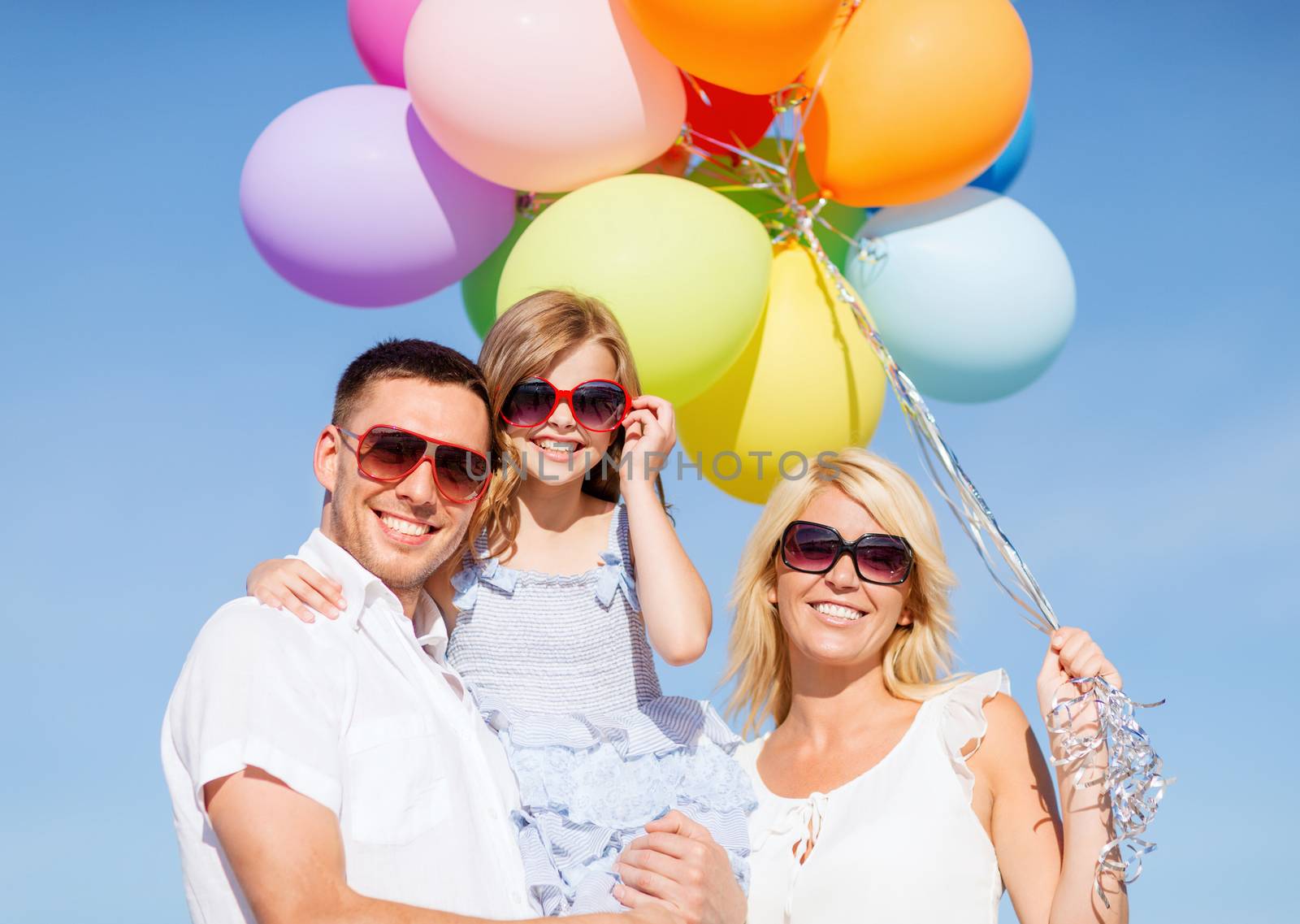 summer holidays, celebration, children and people concept - family with colorful balloons