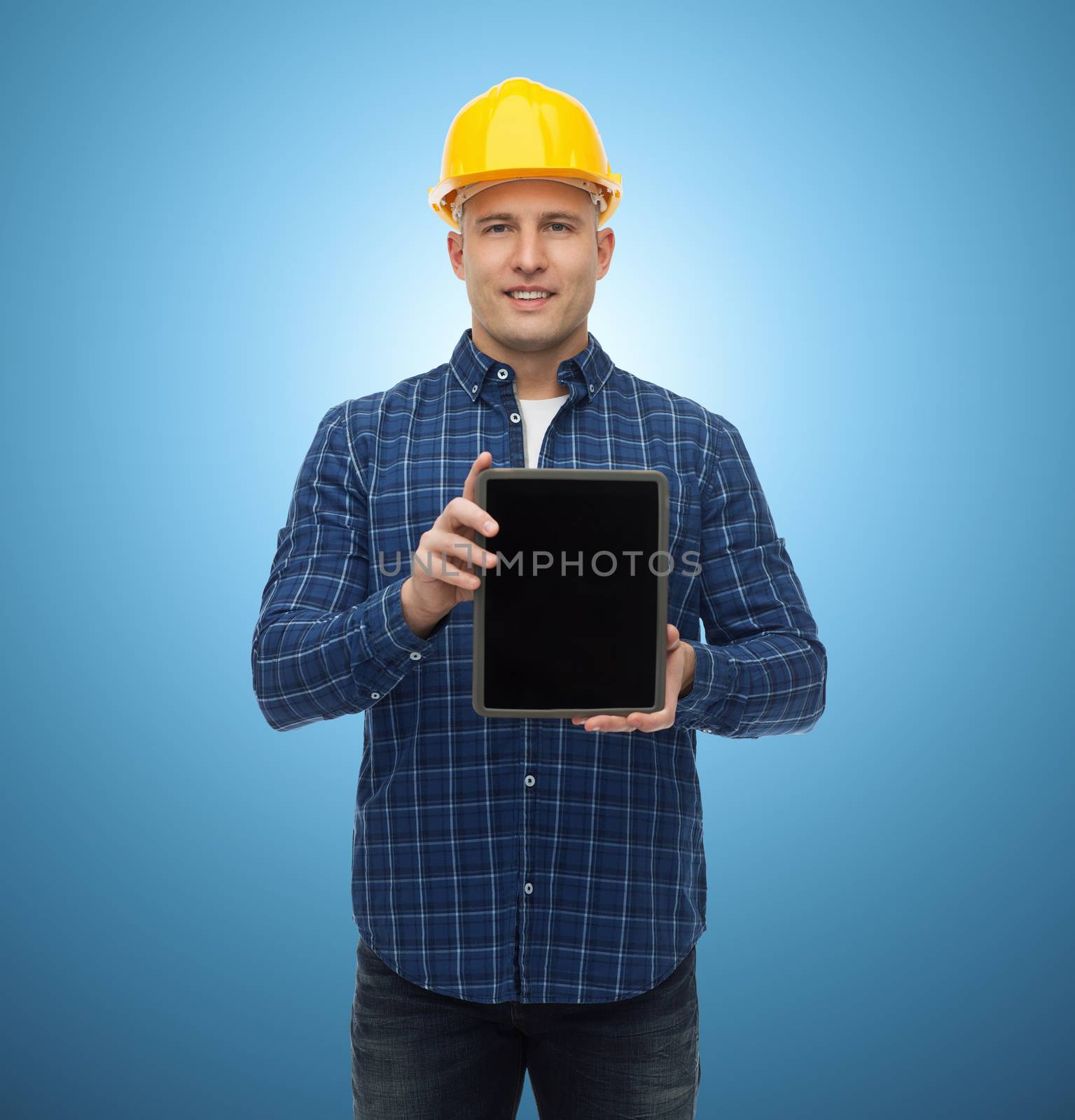 repair, construction, building, people and maintenance concept - smiling male builder or manual worker in helmet showing tablet pc computer blank screen over blue background