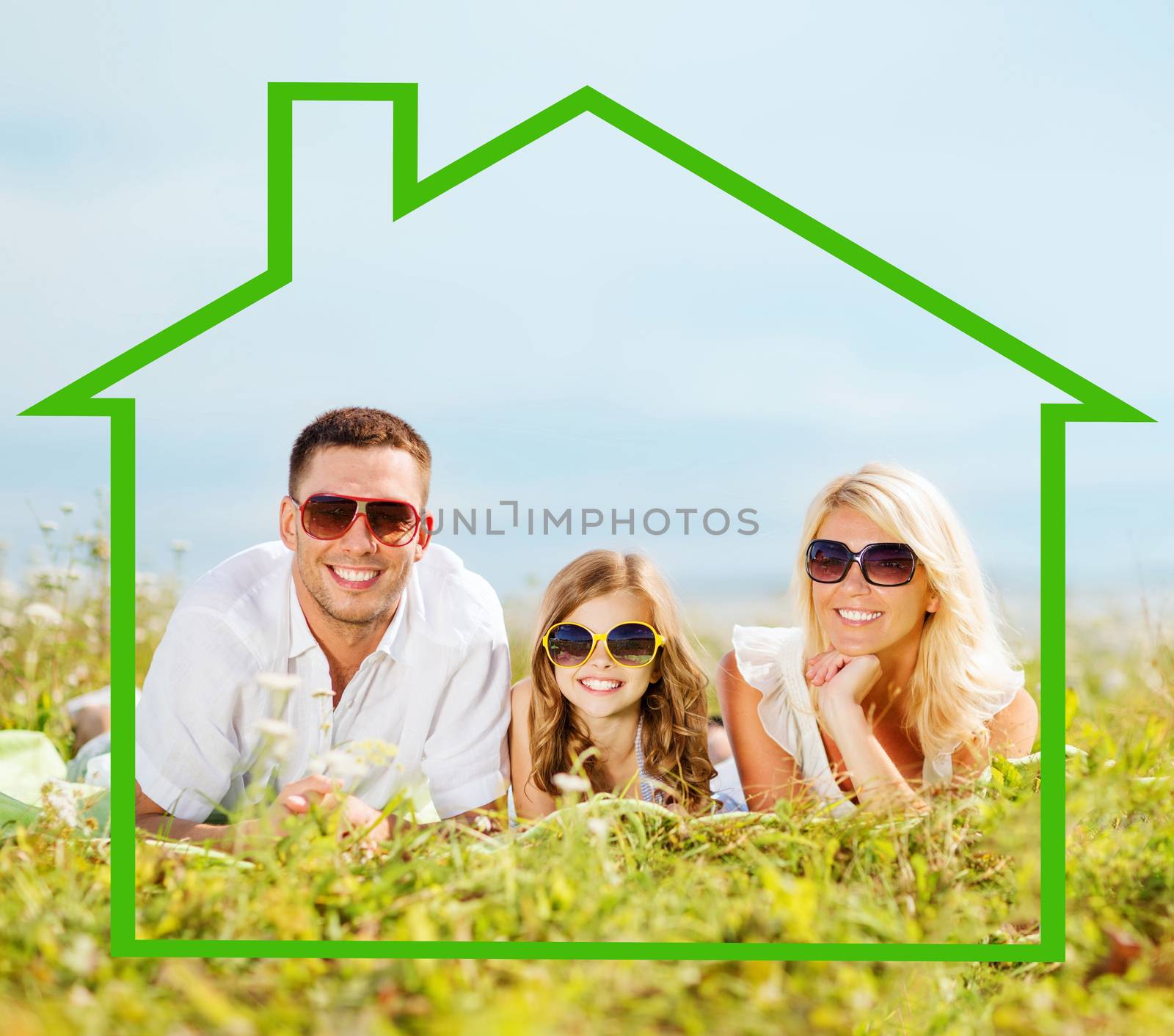 home, happiness and real estate concept - happy family in sunglasses lying on a grass with house shaped illustration