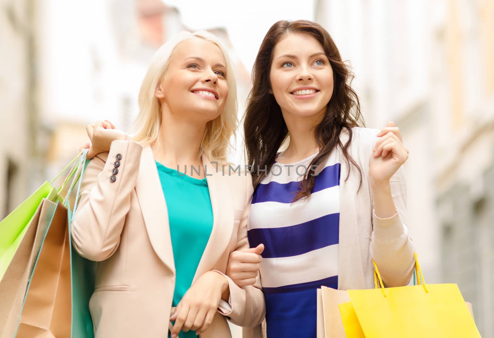 beautiful women with shopping bags in the ctiy by dolgachov