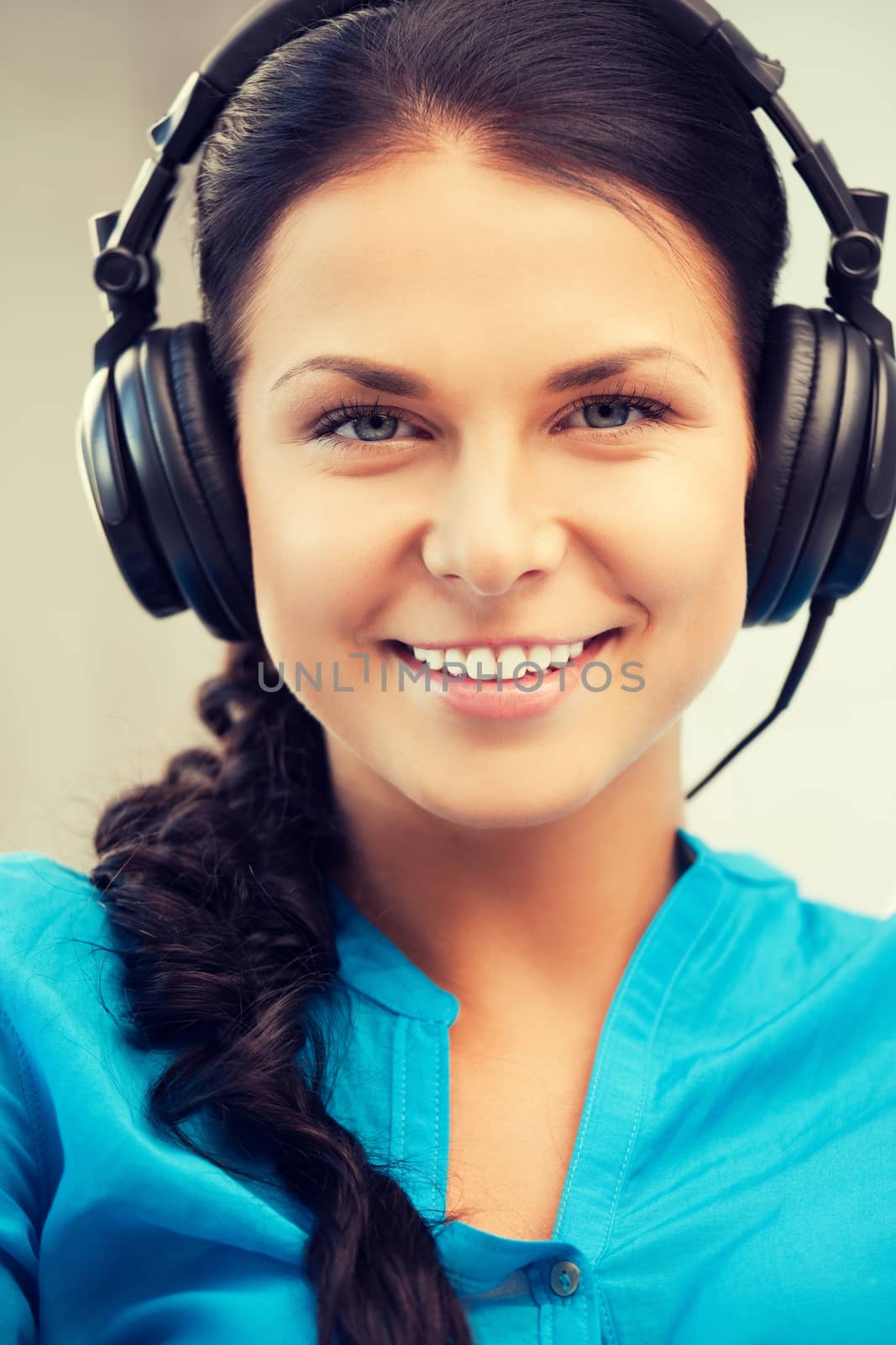 happy teenage girl in big headphones by dolgachov