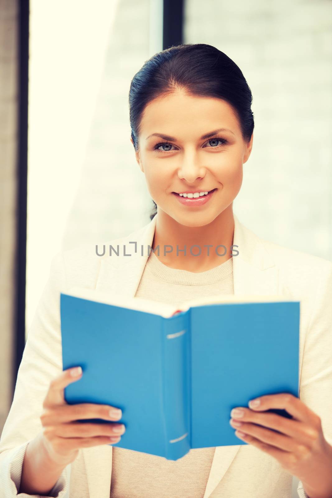 happy and smiling woman with book by dolgachov