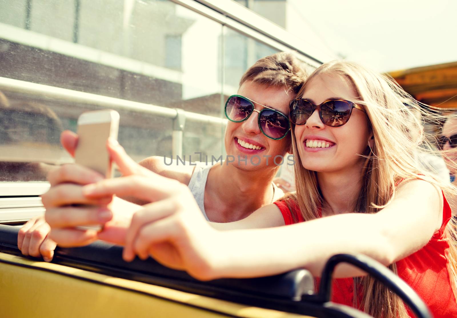 smiling couple with smartphone making selfie by dolgachov