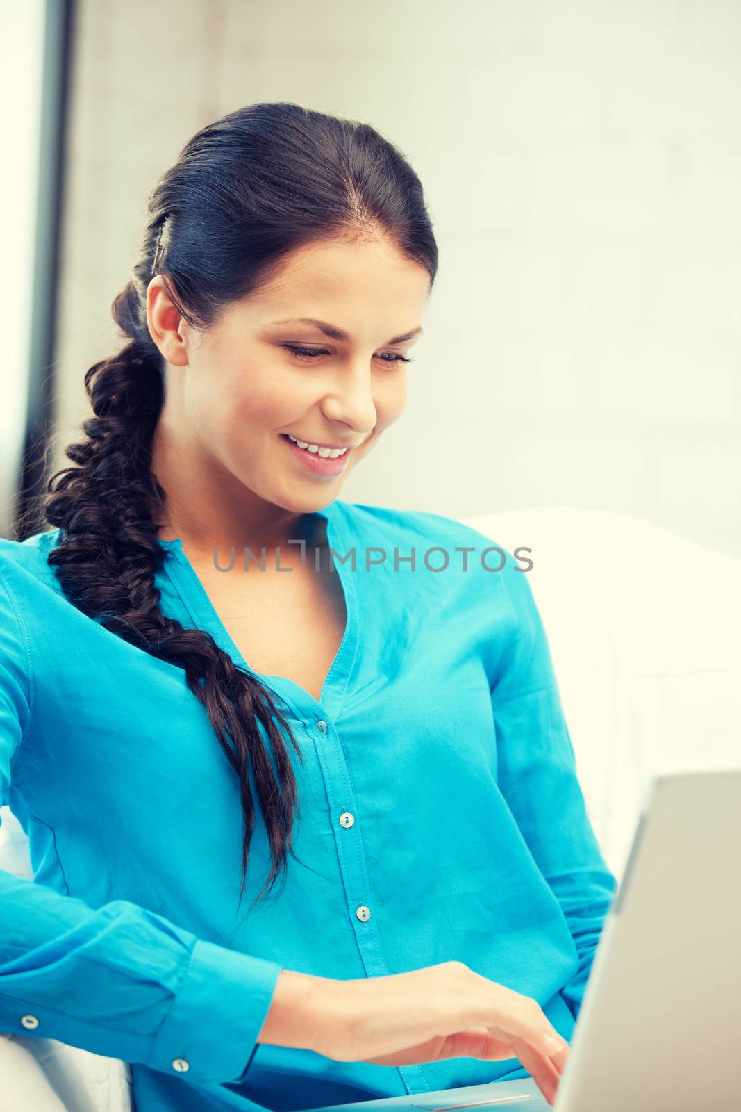 happy woman with laptop computer by dolgachov