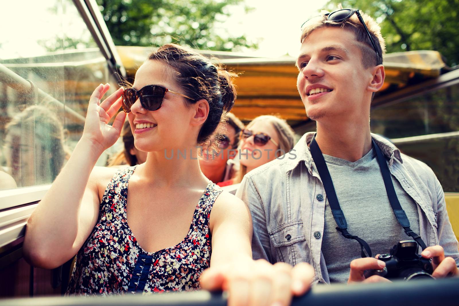 smiling couple with camera traveling by tour bus by dolgachov
