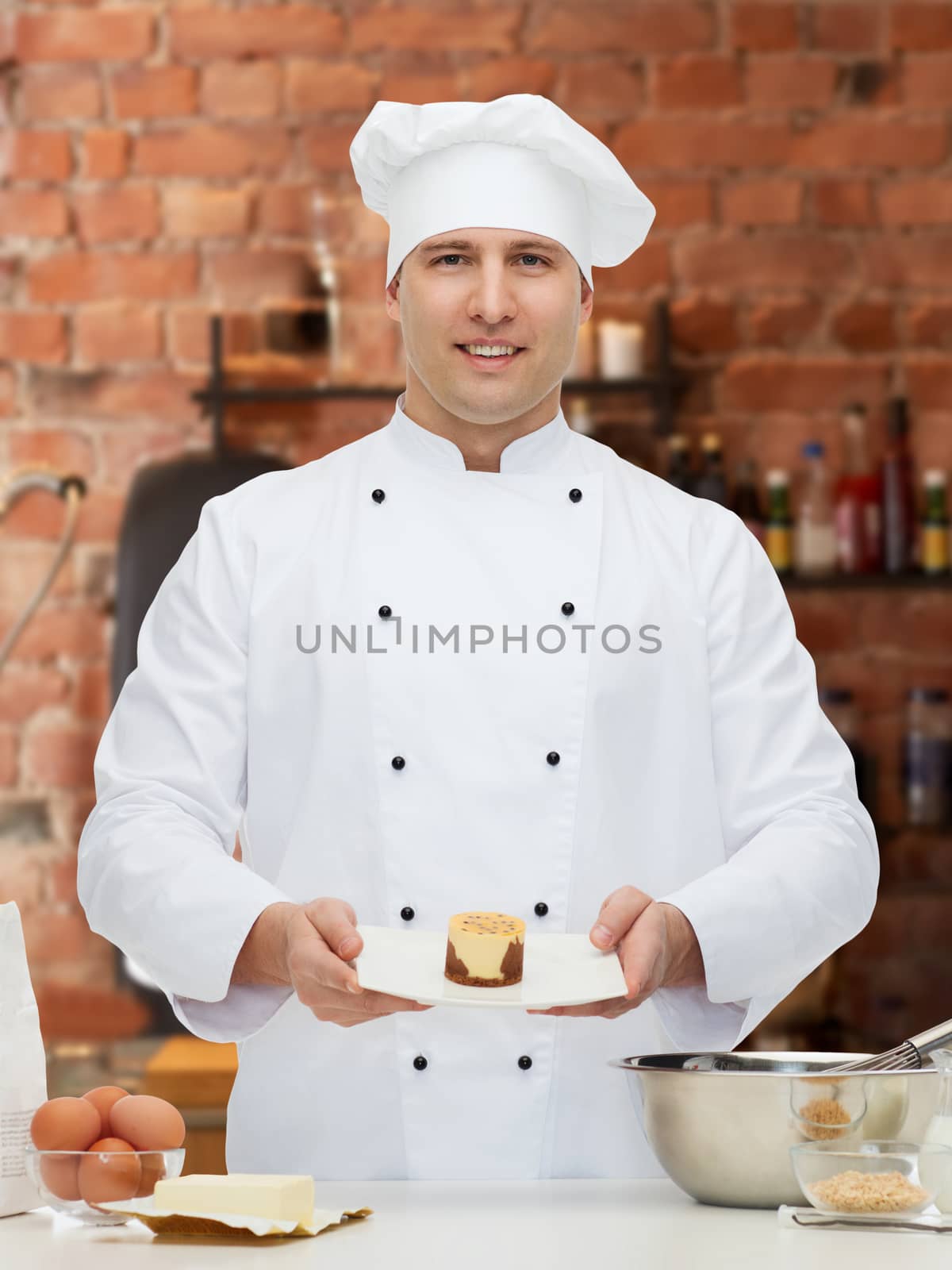 cooking, profession, haute cuisine, food and people concept - happy male chef cook baking dessert over kitchen background